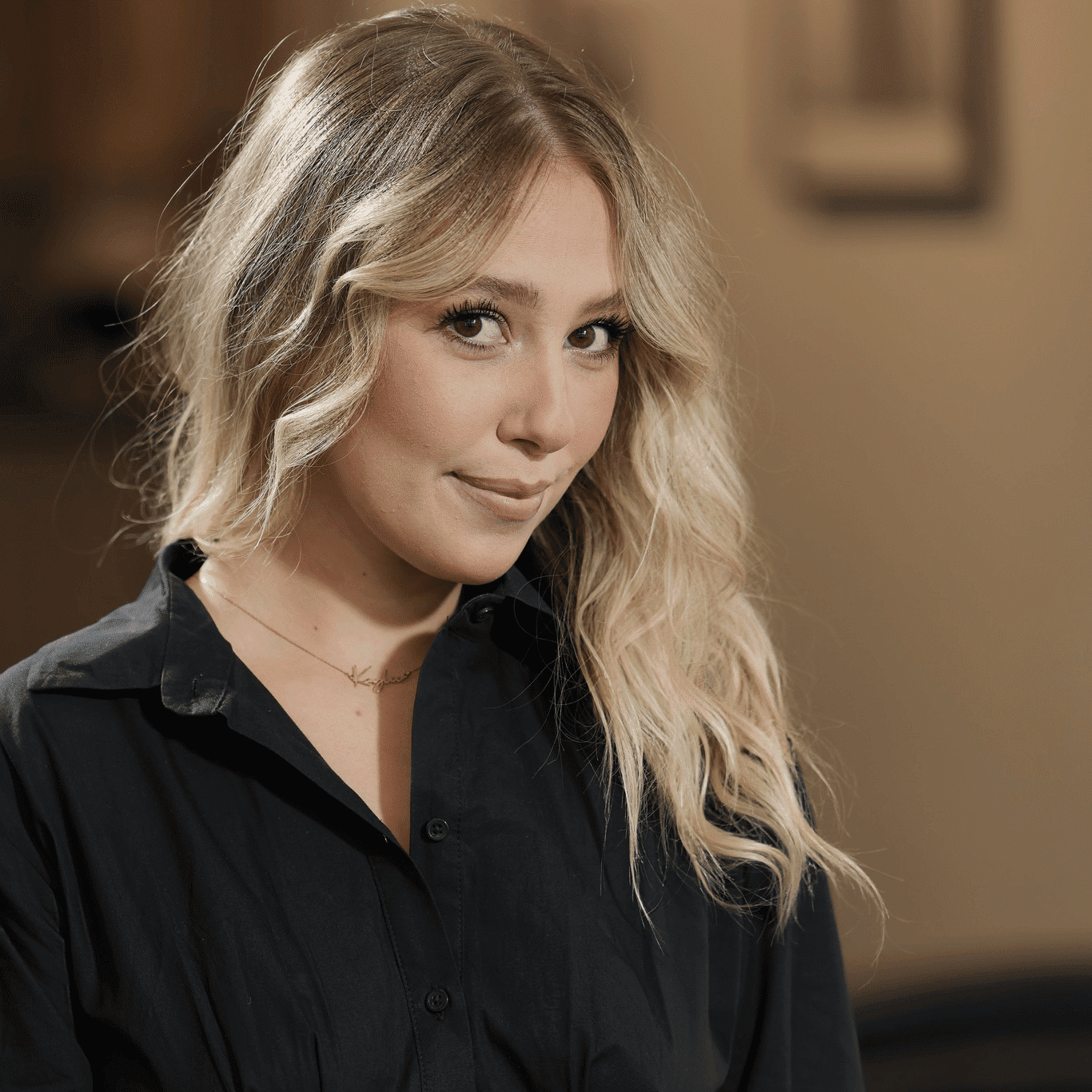 Portrait of Kaylee Palilla, a professional stylist at Atelier, showcasing their expertise and style.