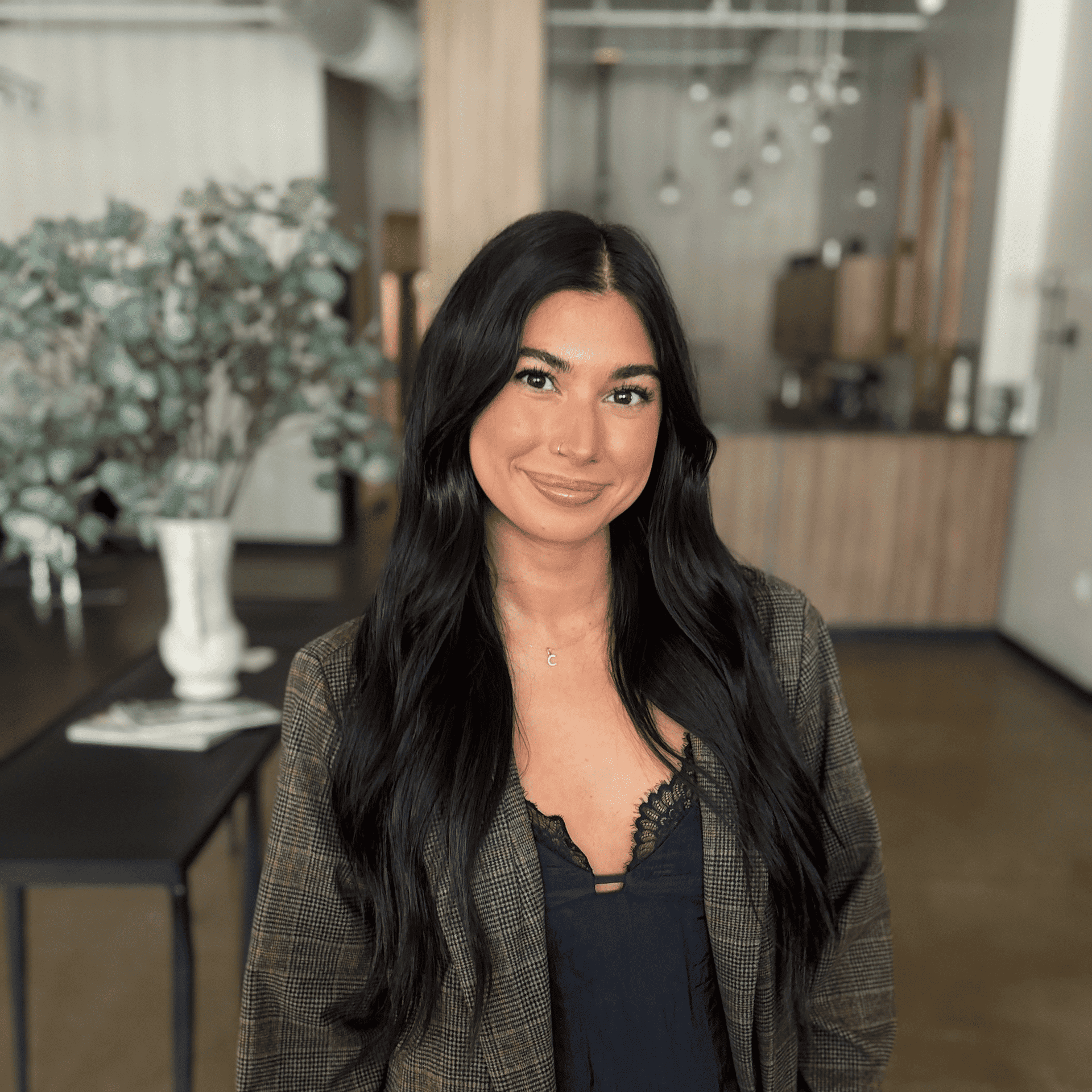 Portrait of Claudia Acevedo, a professional stylist at Atelier, showcasing their expertise and style.