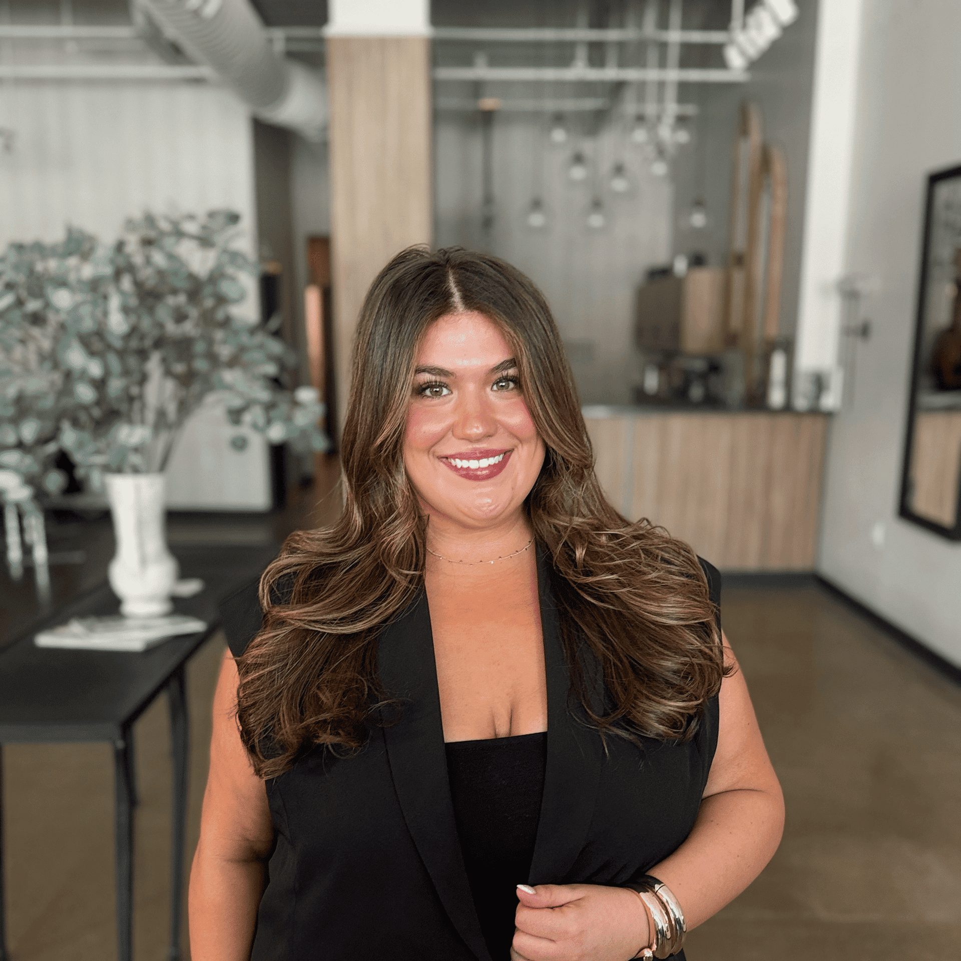Portrait of Montana Grimm, a professional stylist at Atelier, showcasing their expertise and style.