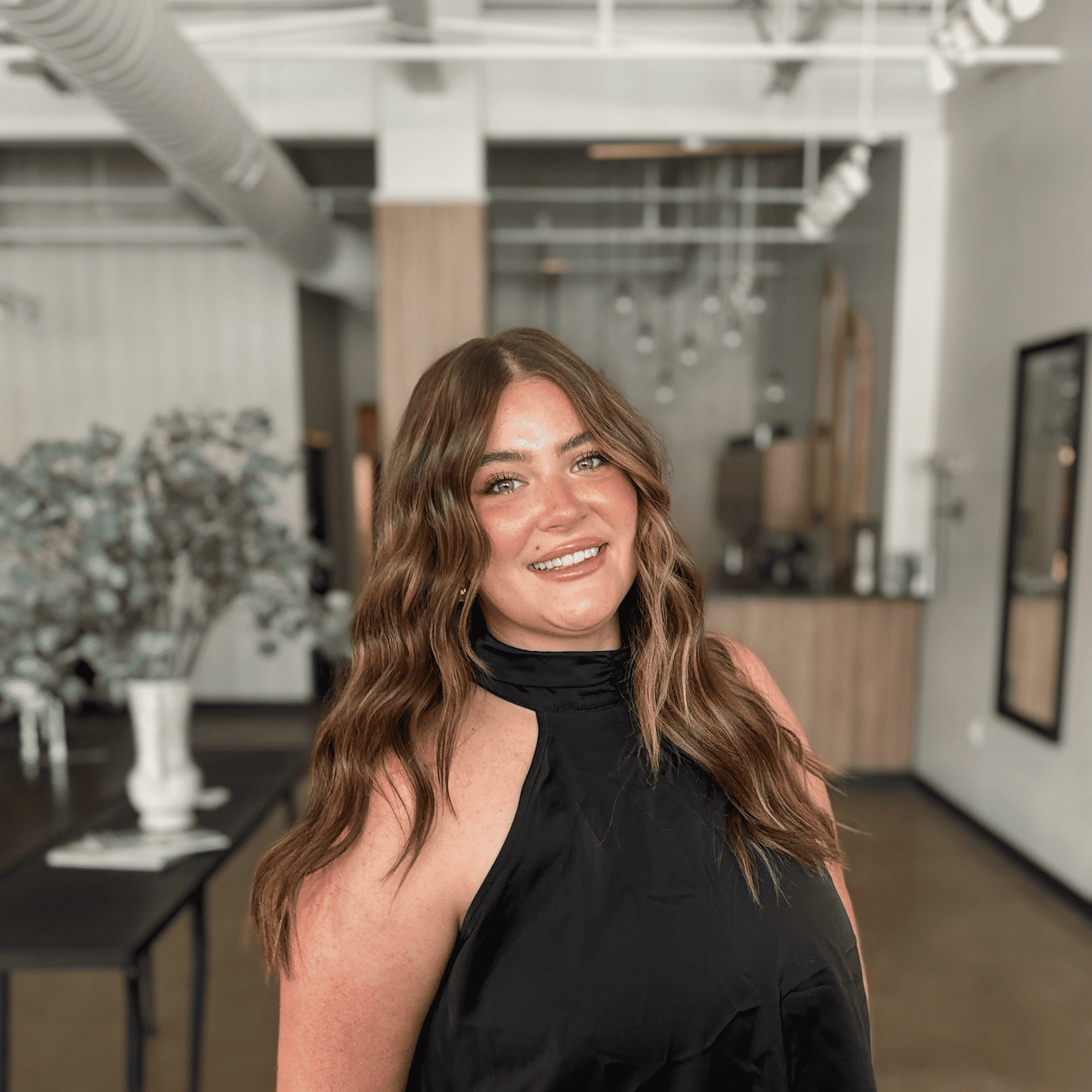 Portrait of Jaycee Prescott, a professional stylist at Atelier, showcasing their expertise and style.
