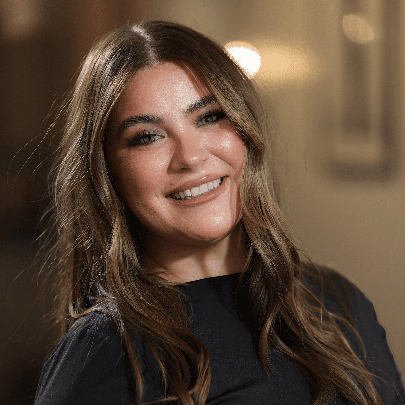 Portrait of Jaycee Prescott, a professional stylist at Atelier, showcasing their expertise and style.