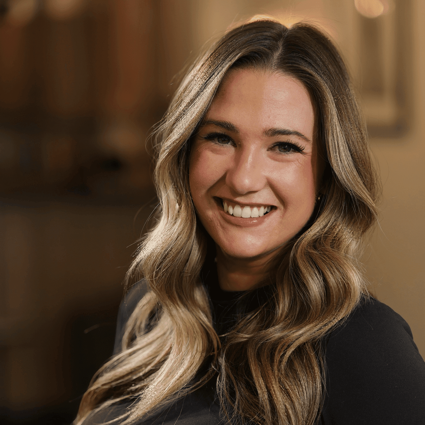 Portrait of Cassi Deluca, a professional stylist at Atelier, showcasing their expertise and style.