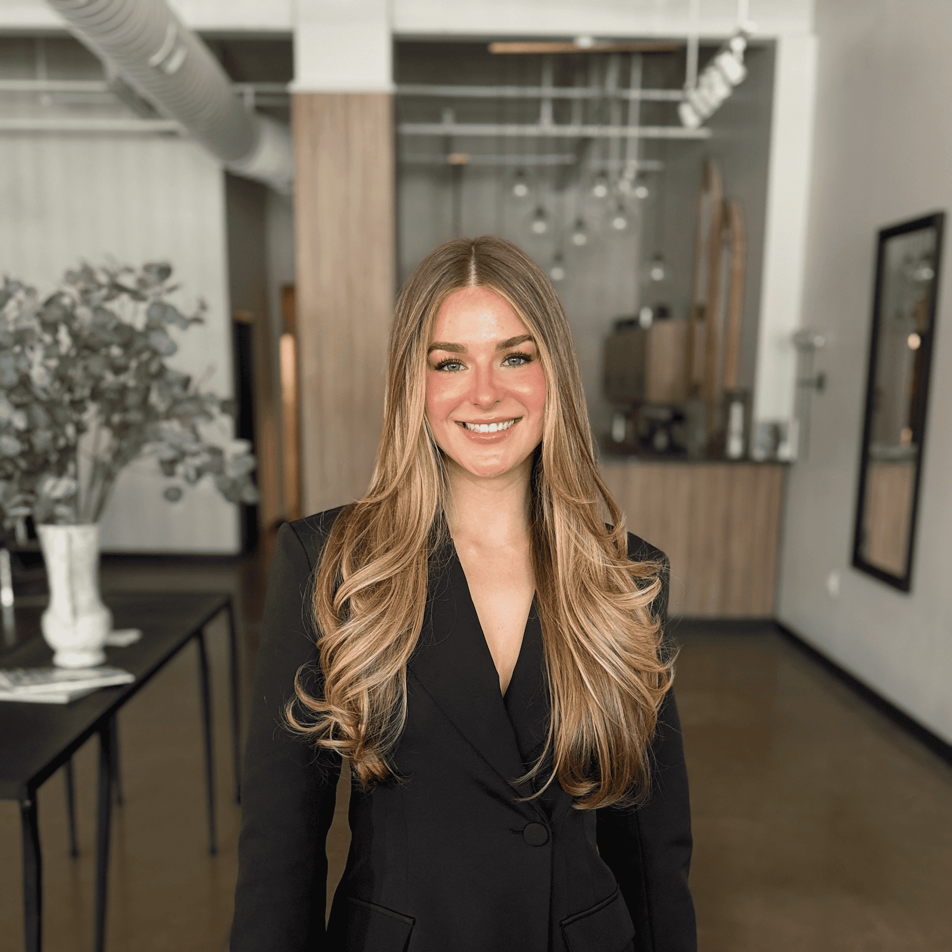 Portrait of Emily Anderson, a professional stylist at Atelier, showcasing their expertise and style.